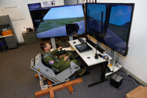 Cadet 1st Class Cody Haggin uses a dynamic motion seat in the Air Force Academy's Warfighter Effectiveness Research Center Oct. 23, 2015. The seat is part of a three-year study to test how using a dynamic motion seat can improve flight training. (U.S. Air Force photo) 